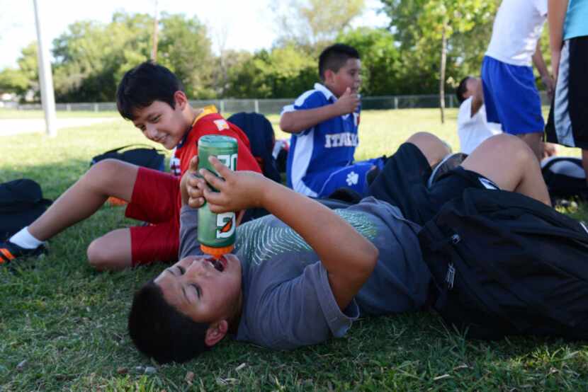 Michael Contreras takes a water break during the soccer team's practice at Strickland...