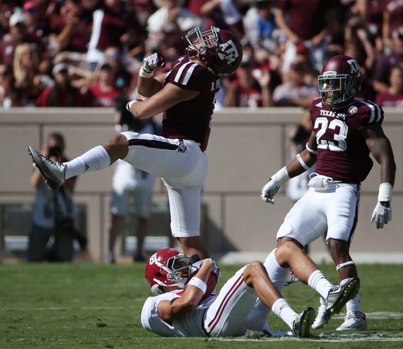 Texas A&M Aggies linebacker Richard Moore (7) celebrates after tackling Alabama Crimson Tide...