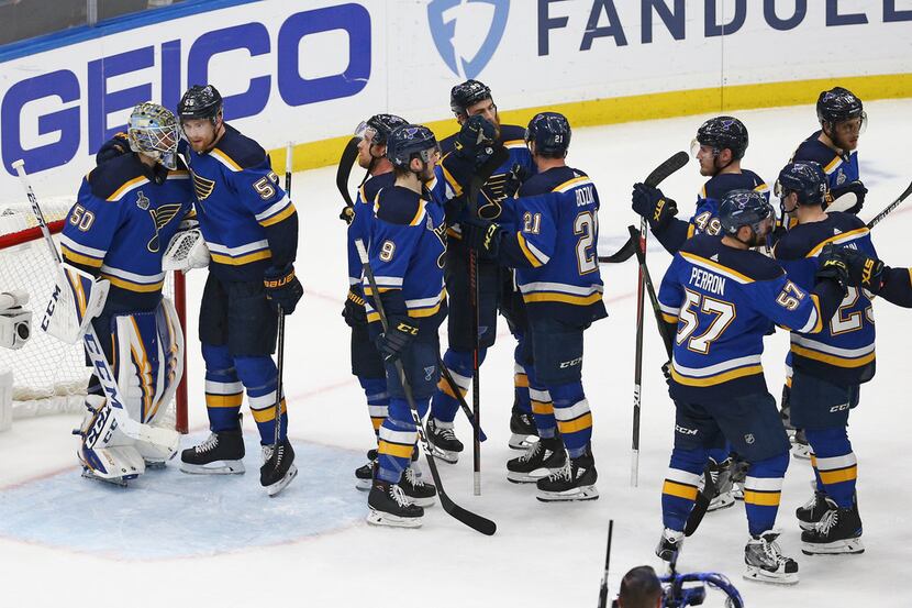 St. Louis Blues players celebrate after beating the Boston Bruins in Game 4 of the NHL...