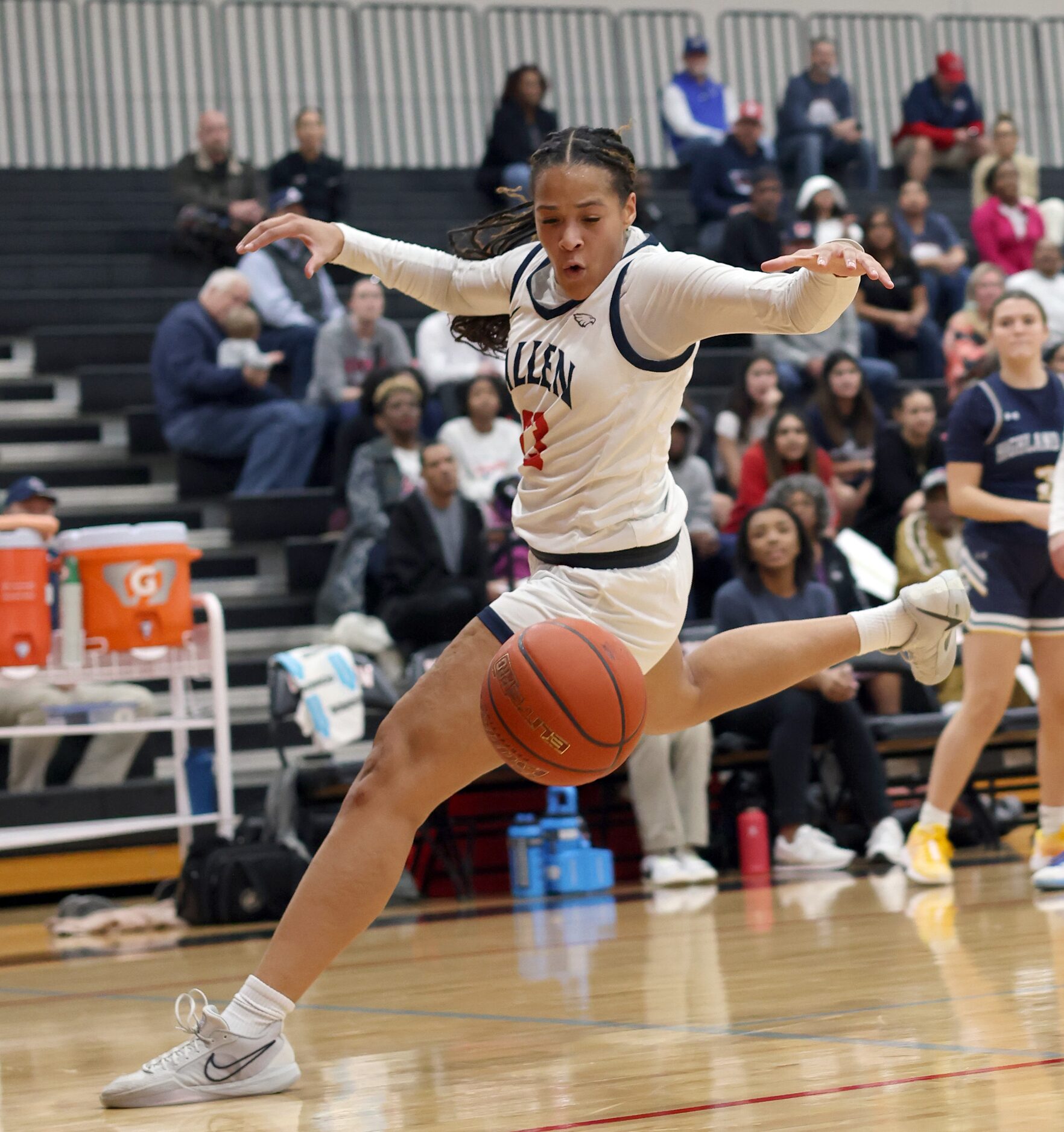 Allen's Aryn Roberts (23) eyes the ball as she races to save it from going out of bounds...