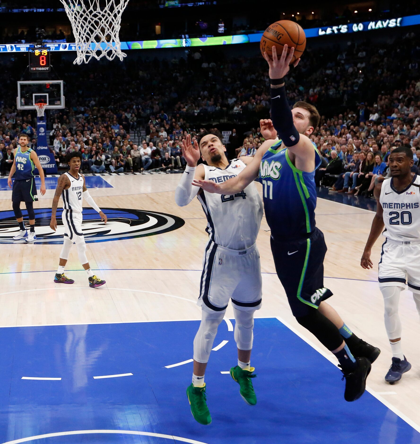 Dallas Mavericks guard Luka Doncic (77) attempts a layup in front of Memphis Grizzlies guard...