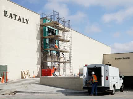 Construction crews work on the exterior of the new Eataly this week at NorthPark Center in...