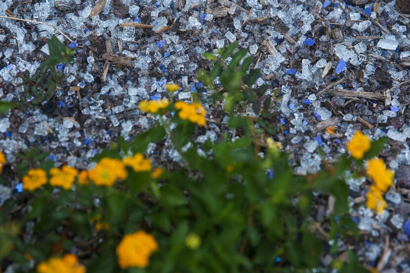 Shards of window glass, which were broken by storms in June, are seen on the ground outside...