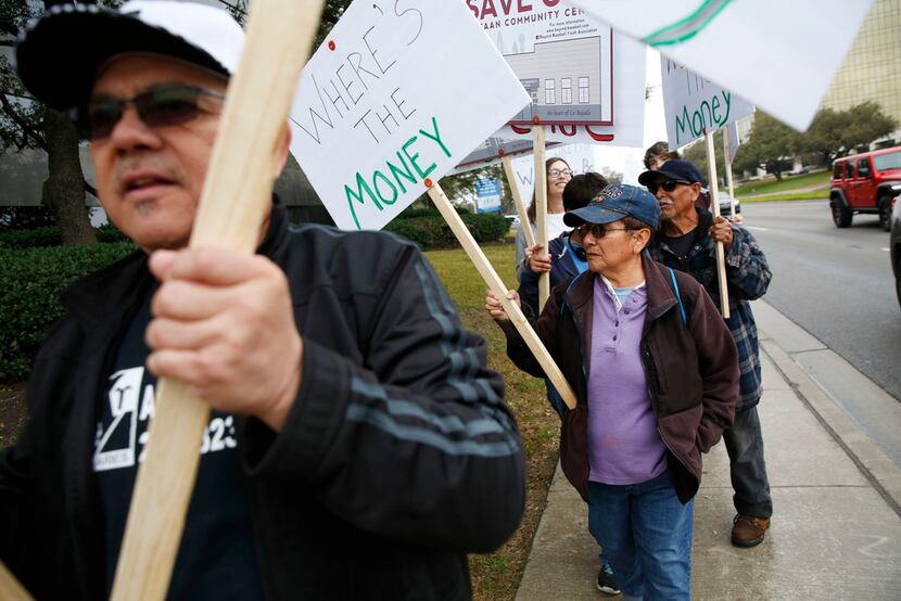 in February, West Dallas residents, including Juanita Hernandez (purple), protested outside...