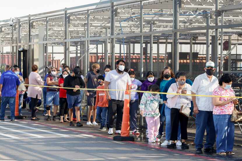 People wait in line at a COVID-19 vaccination clinic at the Walmart on North Cockrell Hill...