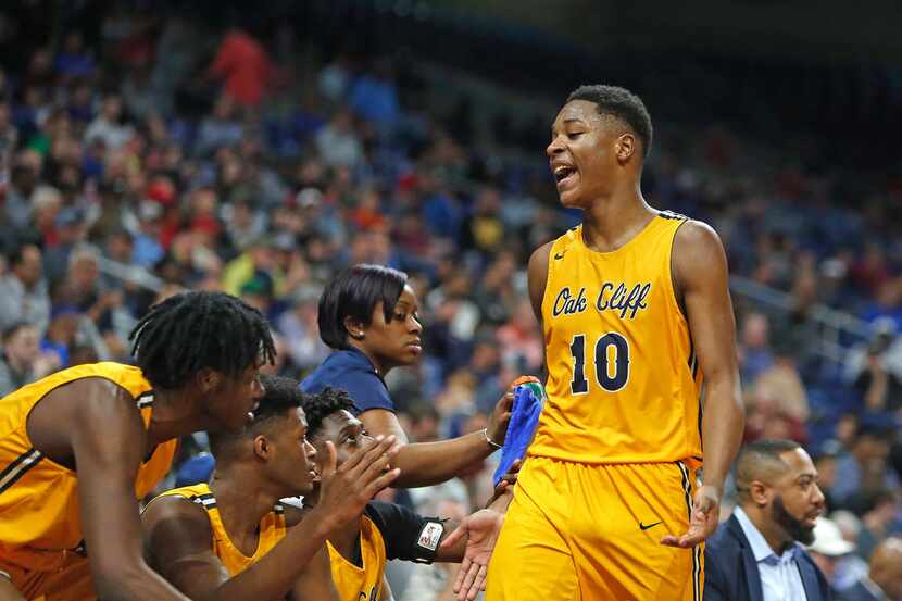 Oak Cliff Faith Academy's Trae Clayton #10 celebrates as he comes to the bench late in the...