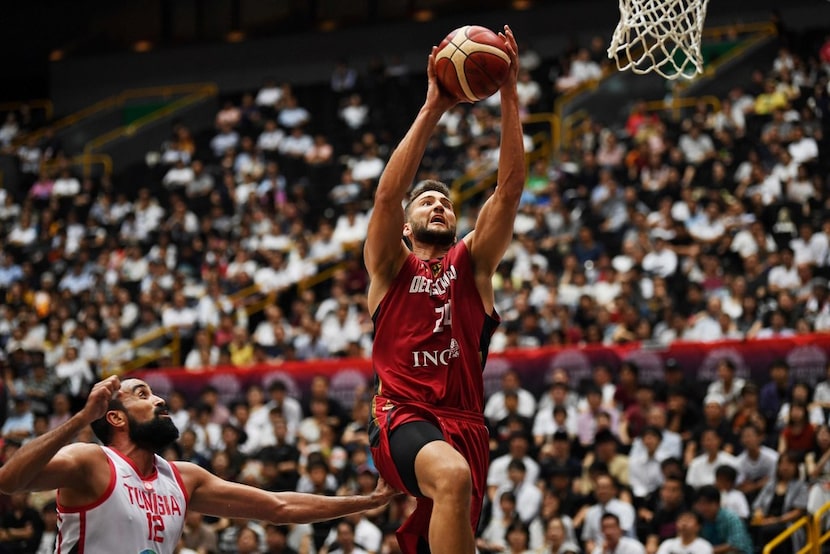 Germany's forward Maximilian Kleber (R) scores as Tunisia's power forward Makram Ben...