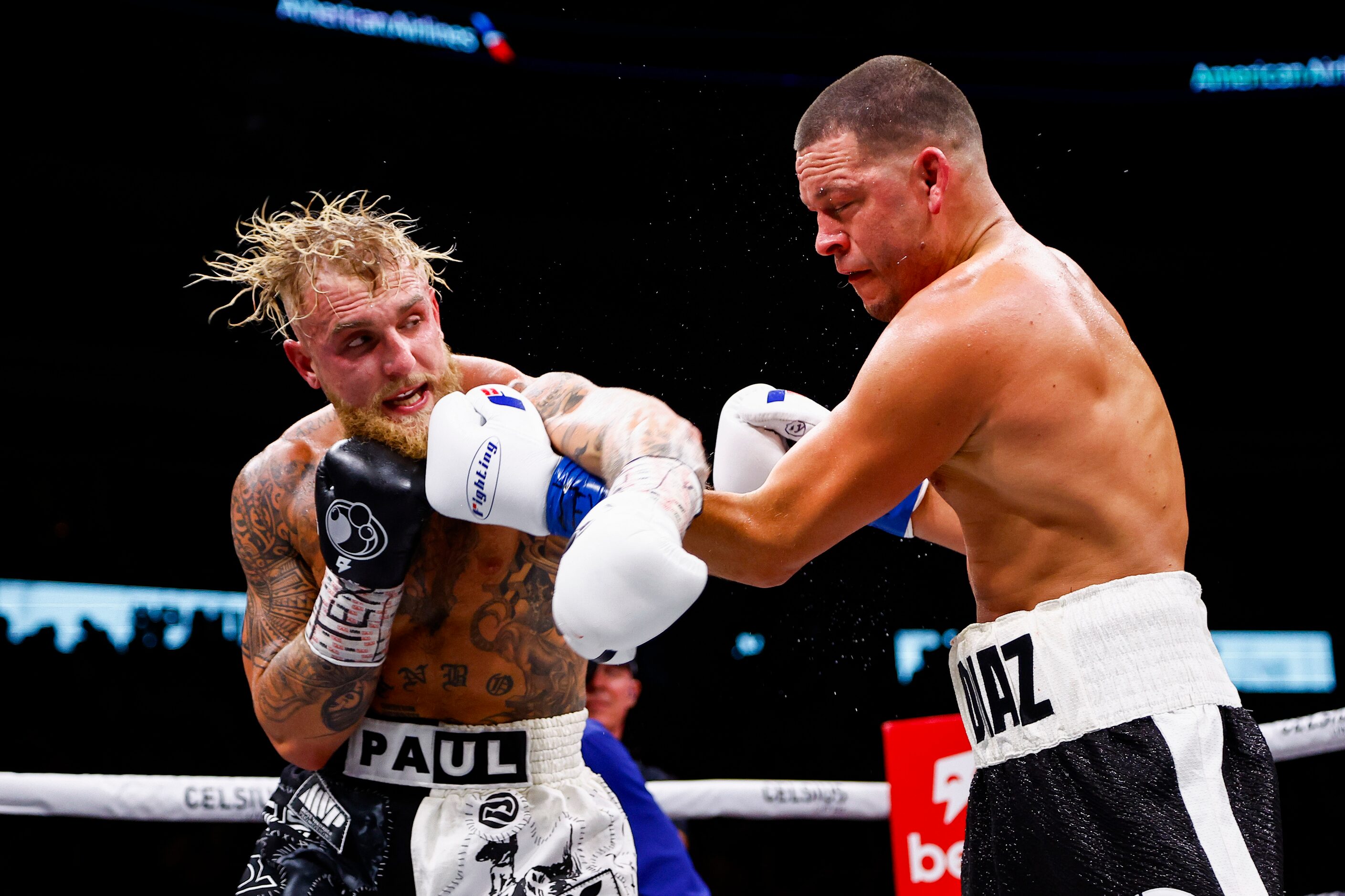 Jake Paul, left, lands a punch on Nate Diaz during a boxing match in Dallas, Saturday,...