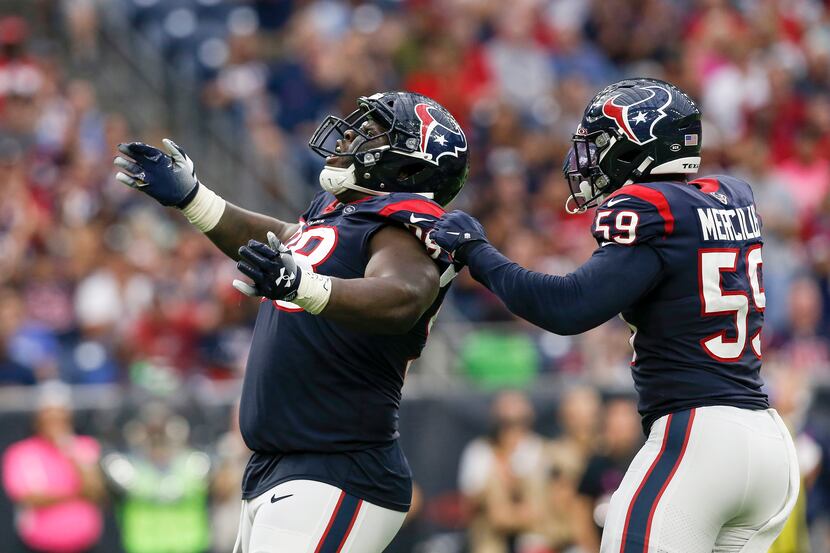 HOUSTON - OCT. 6:  D.J. Reader #98 of the Texans celebrates with Whitney Mercilus #59 after...