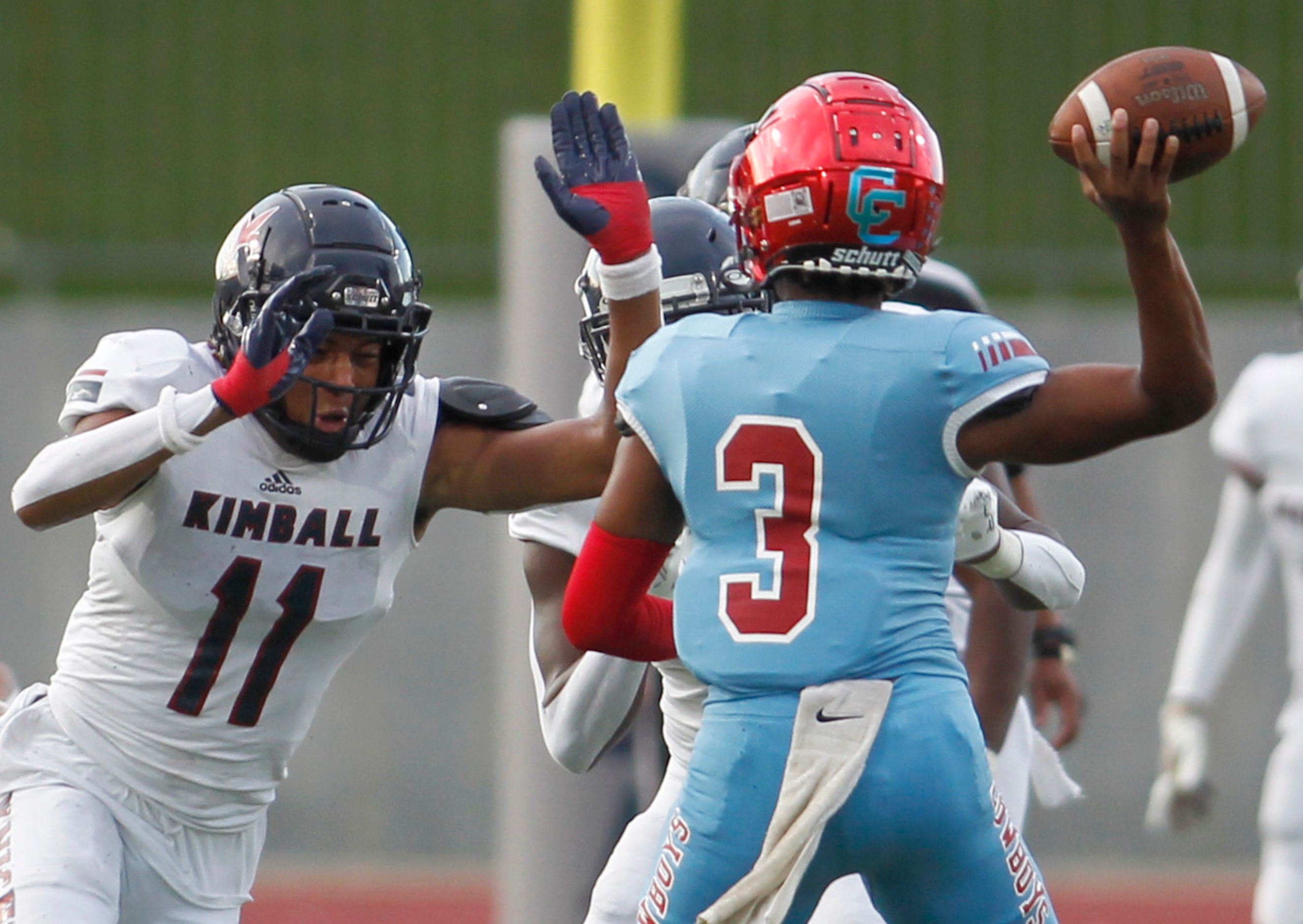 Dallas Carter quarterback Quaylon Robinson (3) gets off a pass while pressured by Dallas...