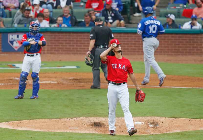 Texas Rangers starting pitcher Yu Darvish (11) reacts after giving up  a third home run in...