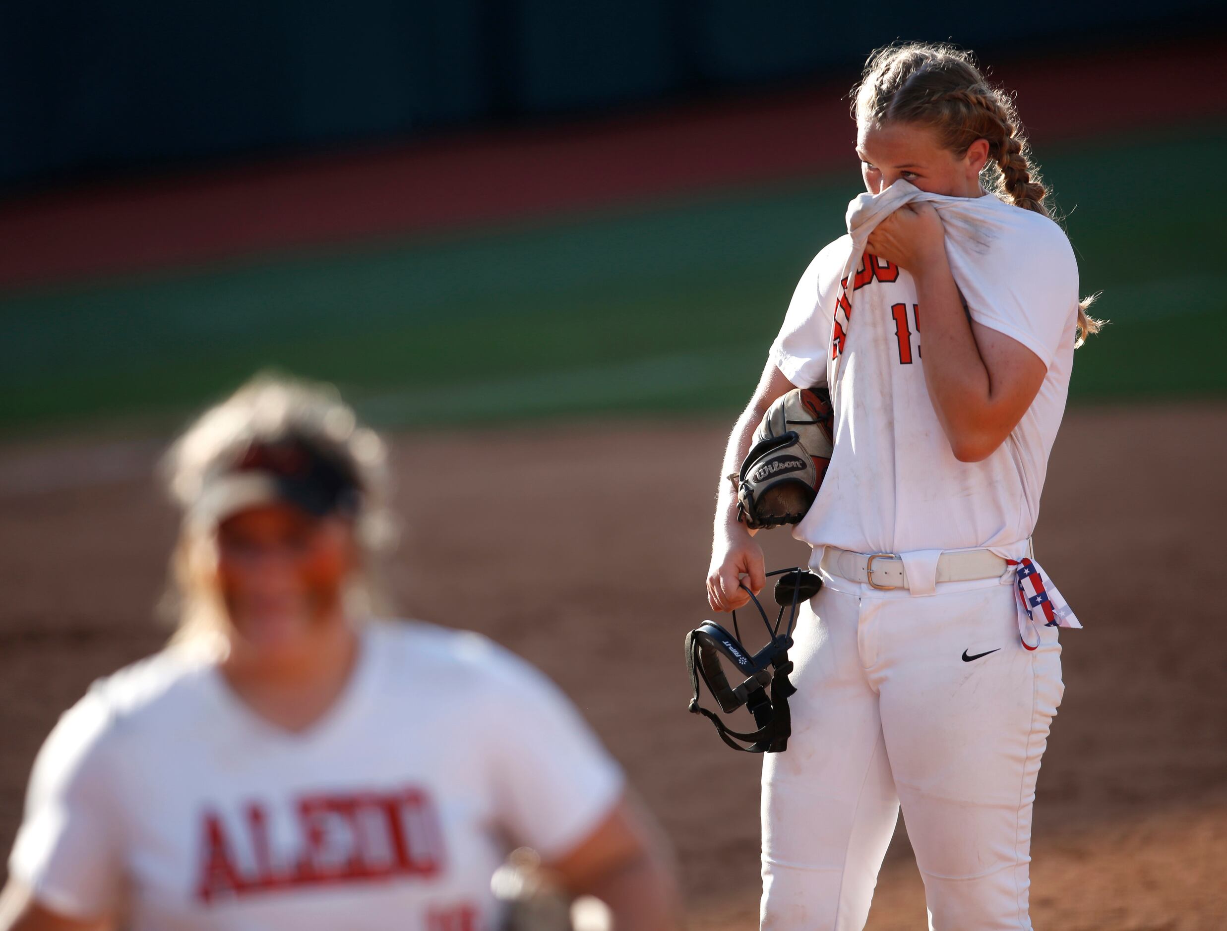 Aledo pitcher Kayleigh Smith (15) wipes away perspiration between batters during the top of...