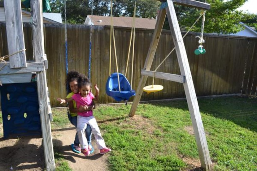 
Kimmy’s daughters swing in the backyard at Emily’s Place. 
