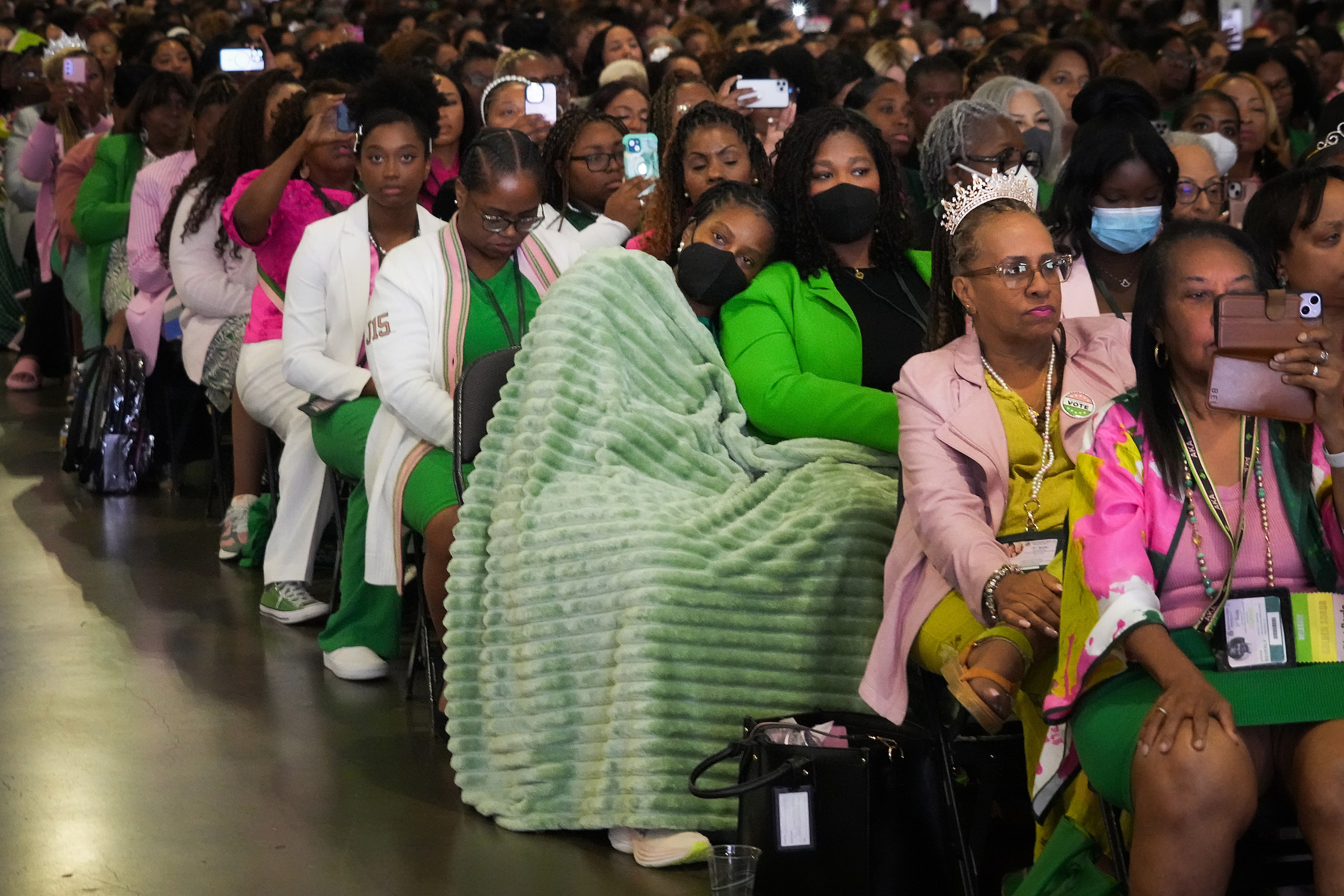 Delegates train their mobile phone cameras on Vice President Kamala Harris as she addresses...