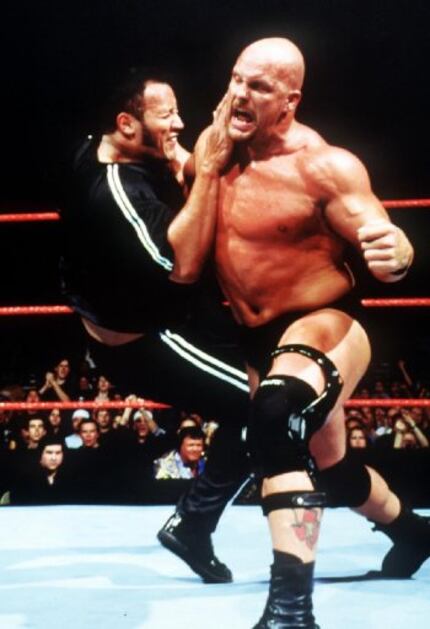 Smackdown!  Stone Cold Steve Austin (right) puts down an opponent.