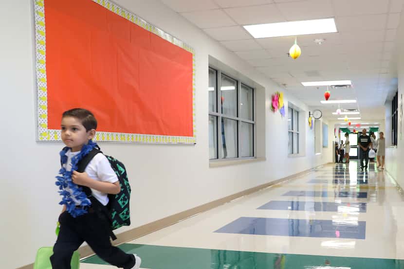 Alonso Guereca, Jr. (left), 5, catches up with classmates as his parents Martina Guereca...