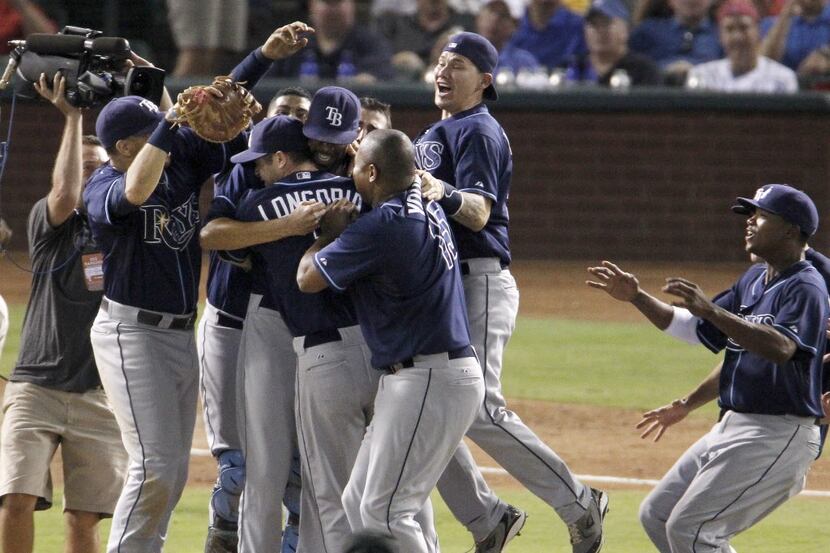 The Tampa Bay Rays mob Tampa Bay Rays starting pitcher David Price (14) after he pitched a...