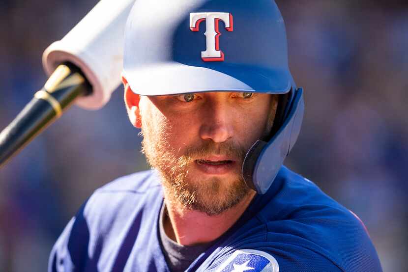 Texas Rangers designated hitter Hunter Pence takes practice swings on deck before hitting...