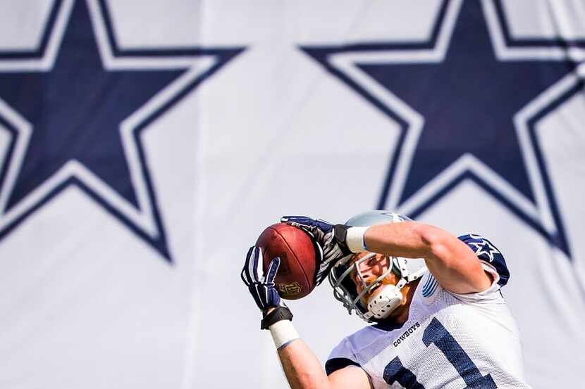 Dallas Cowboys wide receiver Cole Beasley catches a pass during practice at training camp on...