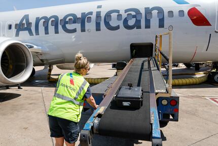 American Airlines flight service clerk Kayce Strength loads a suitcase with a GoPro onto an...
