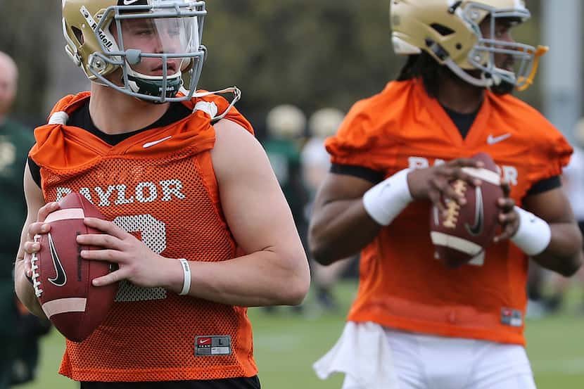 Baylor quarterbacks Charlie Brewer, left, and Gerry Bohannon throw during the team's first...