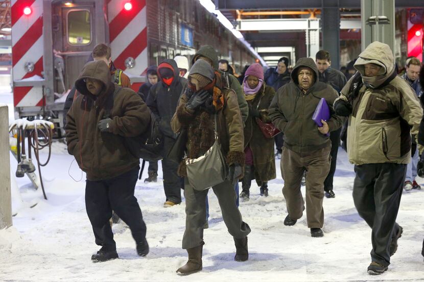 Commuters arrive at the La Salle Street commuter rail station as they experience...
