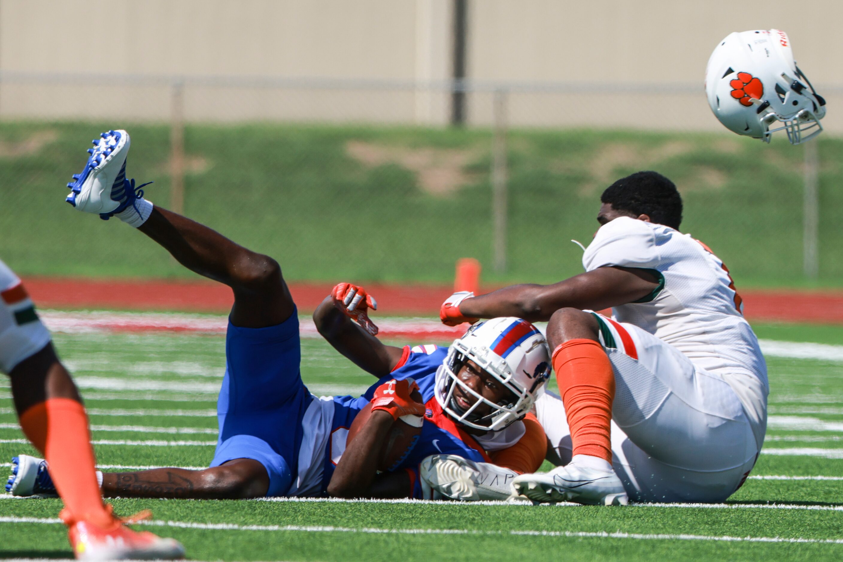 Duncanville High School Lamoderick Spencer (3) gets taken down by Jones High School Dylan...