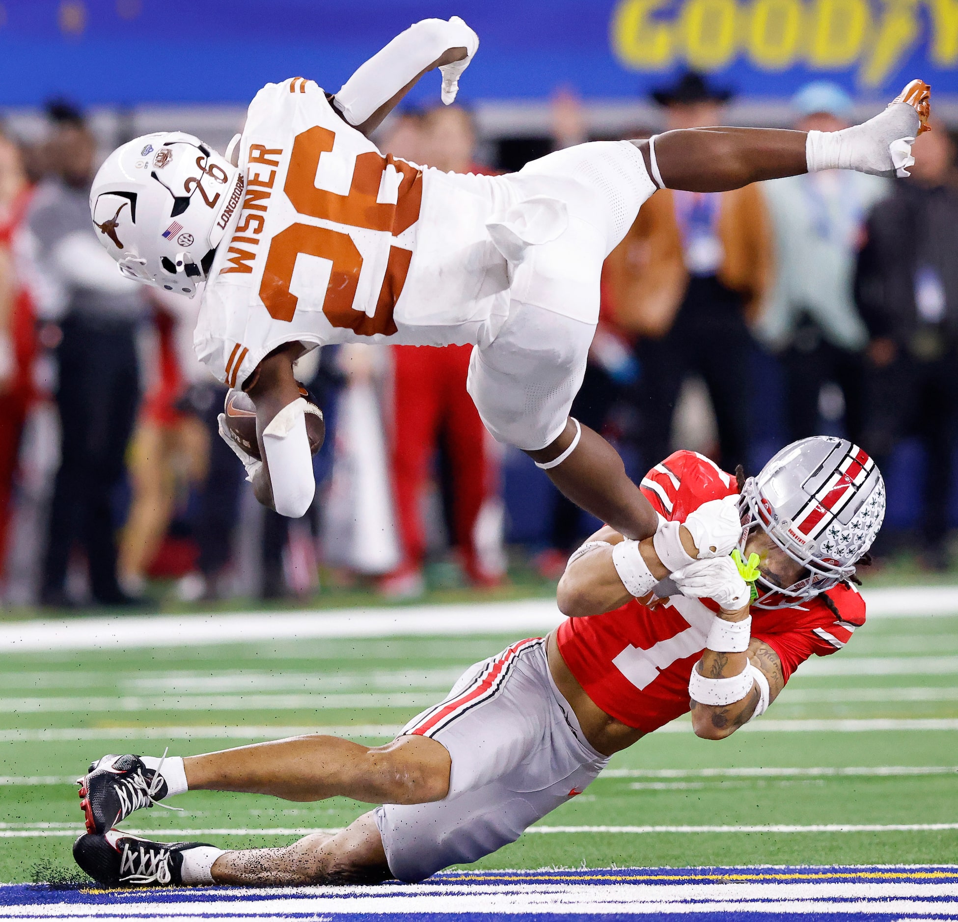 Texas Longhorns running back Quintrevion Wisner (26) is snagged in mid-air as he tried to...