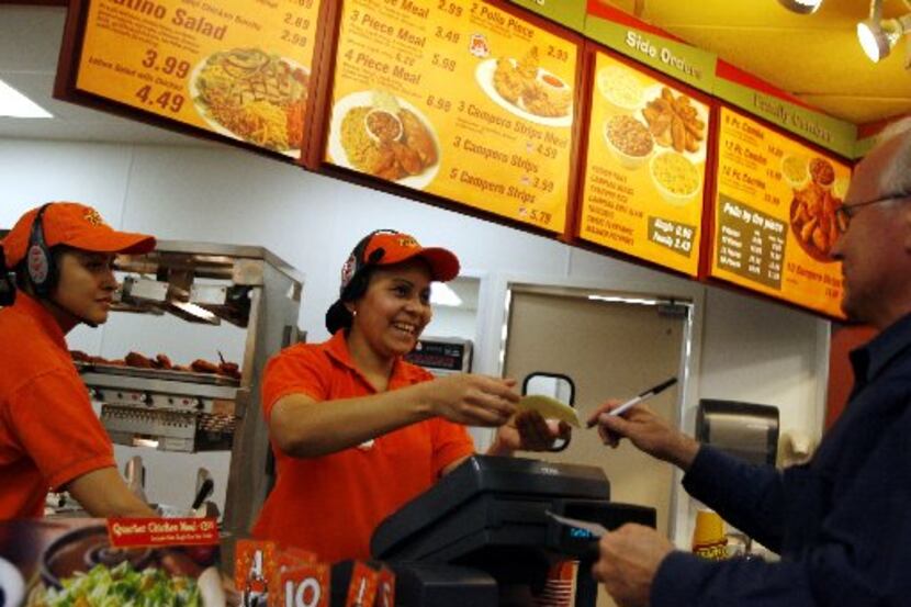 Claudia Perez, an employee with Pollo Campero, helps customer David Goyen at a Dallas store...