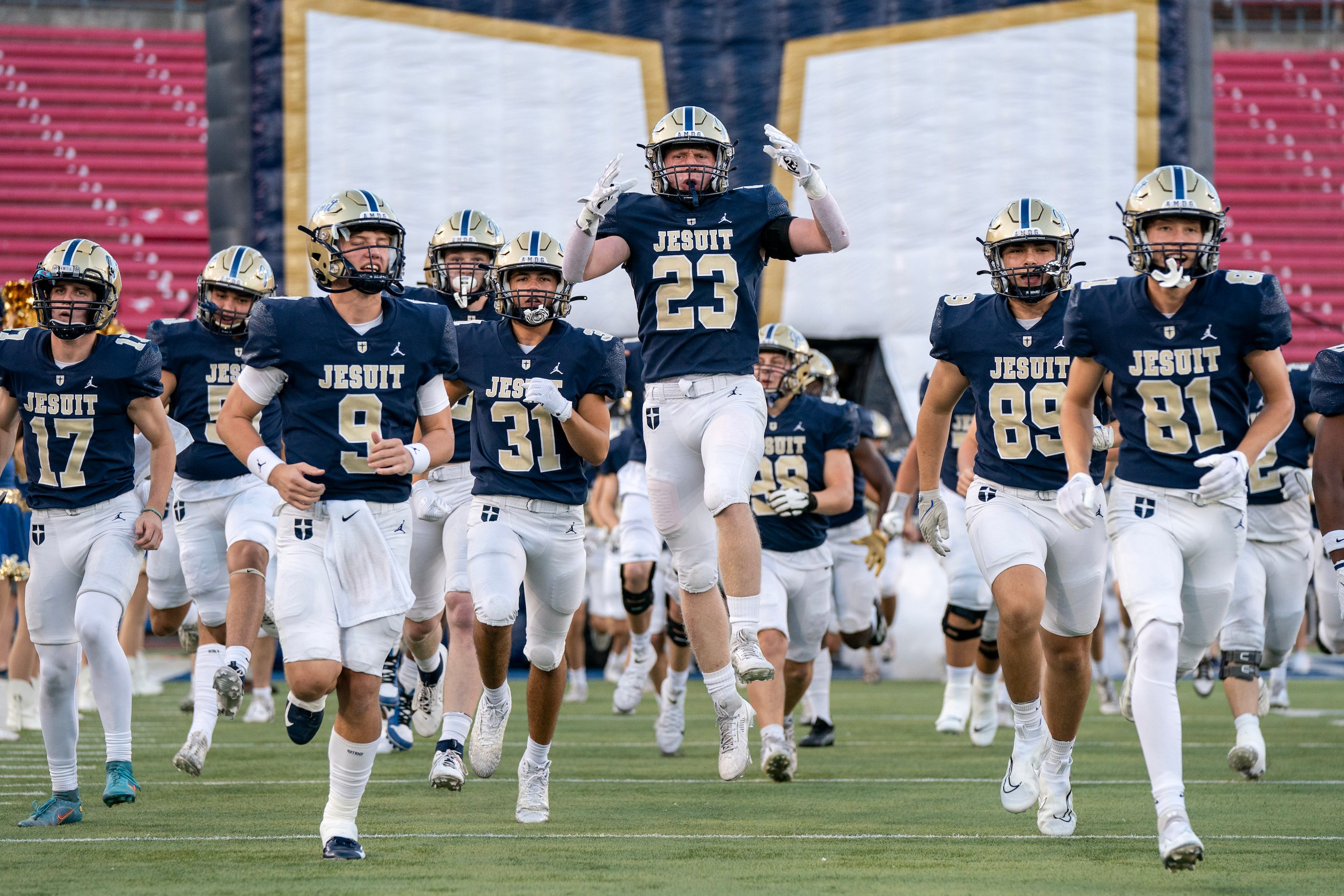 Jesuit senior linebacker Drew Noonan (23) leaps as his team takes the field before a high...