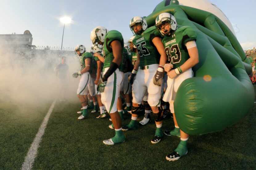 The Southlake Carroll Dragons take the field before a Class 5A high school football game...