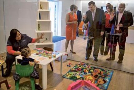  Mayor Mike Rawlings and Councilman Adam Medrano tour a children's playroom at the YW...