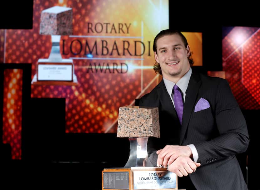 Ohio State's Joey Bosa poses with the Rotary Lombardi Award trophy Wednesday, Dec. 9, 2015,...