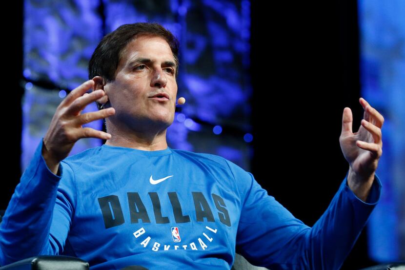Dallas Mavericks owner Mark Cuban, right, answers question from Scott Murray during the 63rd...