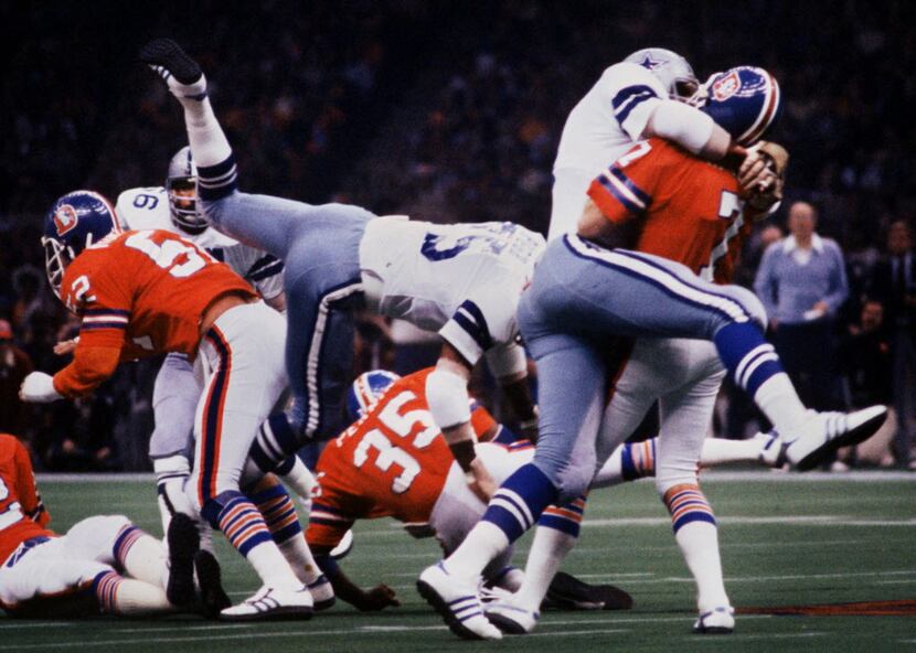 The Dallas Cowboys 'DoomsDay' defense, including Harvey Martin (79 - atop the Denver QB) and...