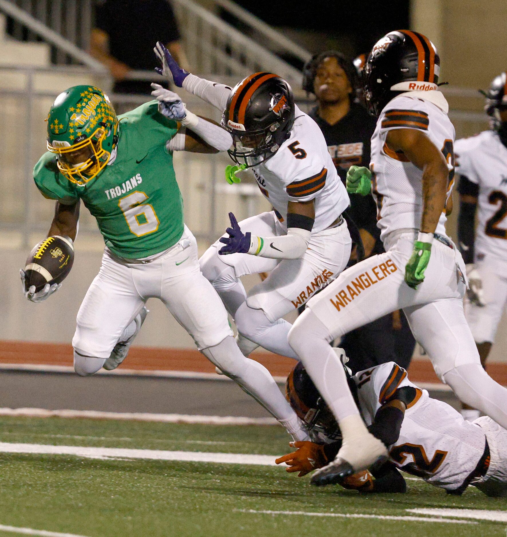 Newman Smith's Allijah Harrison (6) keeps the ball away from West Mesquite's Aiden Rusk (5)...