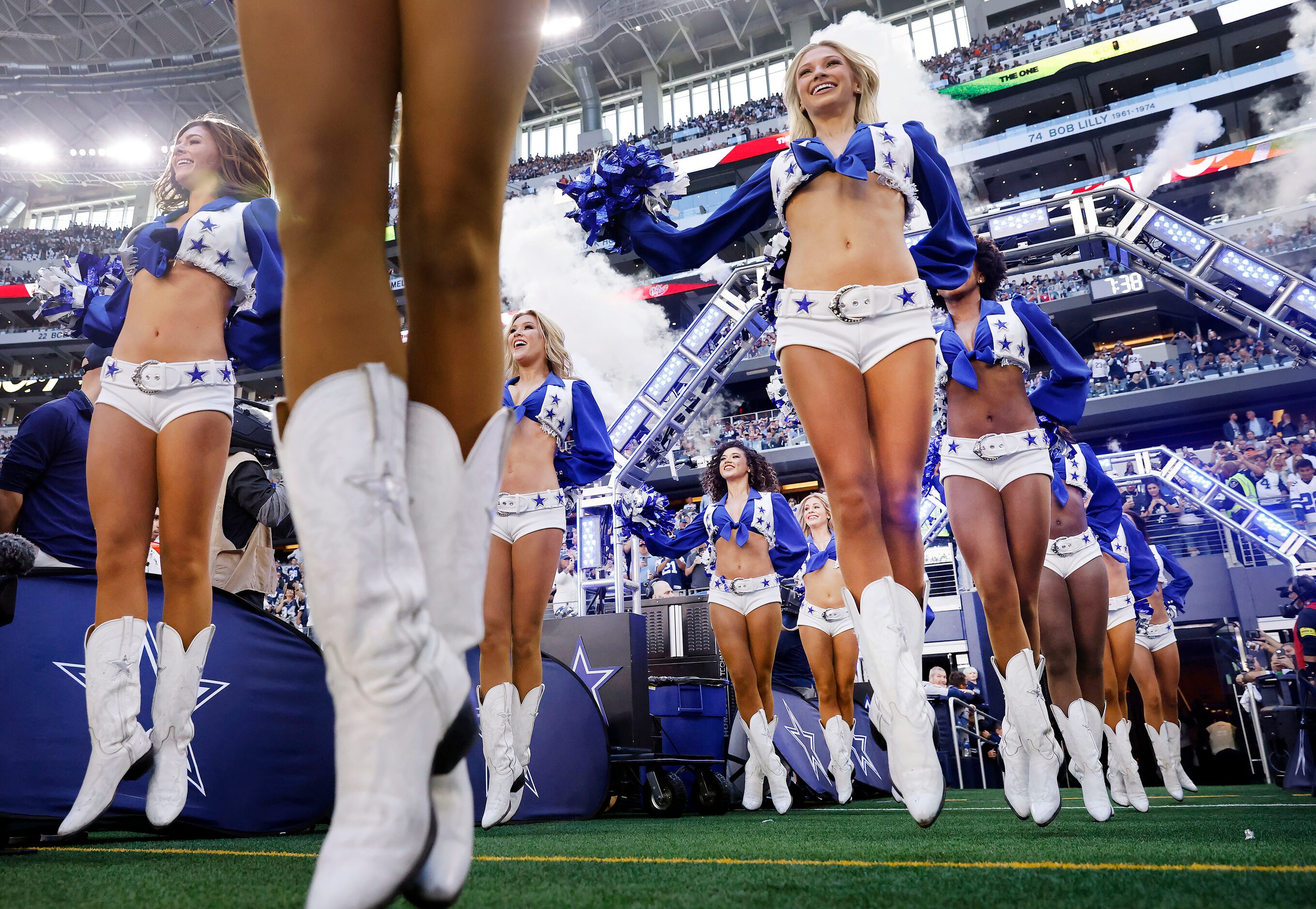 The Dallas Cowboys Cheerleaders skip as they take the field before the team before their...