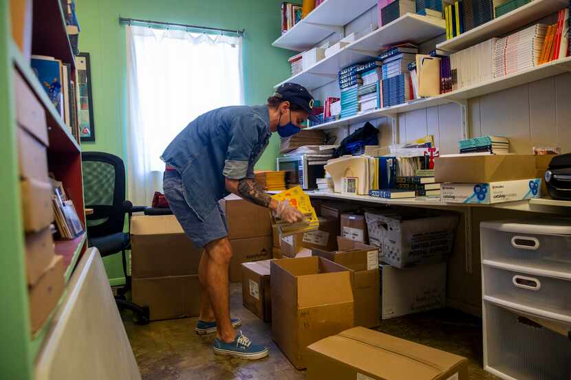 Will Evans, executive director of Deep Vellum Publishing, packages online orders for at Deep...