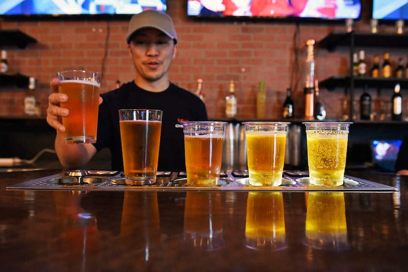 Co-owner Danny Doan demonstrates how a "bottoms up" draft beer system works at BB.Q Chicken...