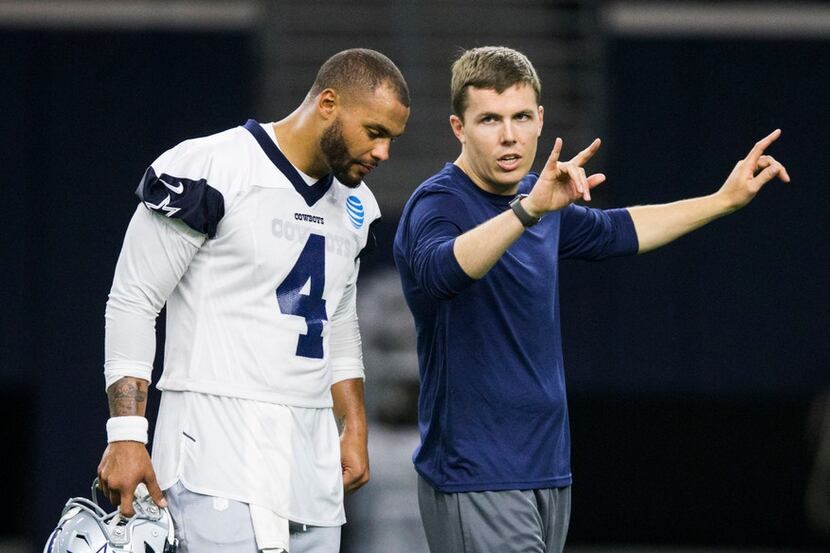 Dallas Cowboys offensive coordinator Kellen Moore talks to quarterback Dak Prescott (4)...