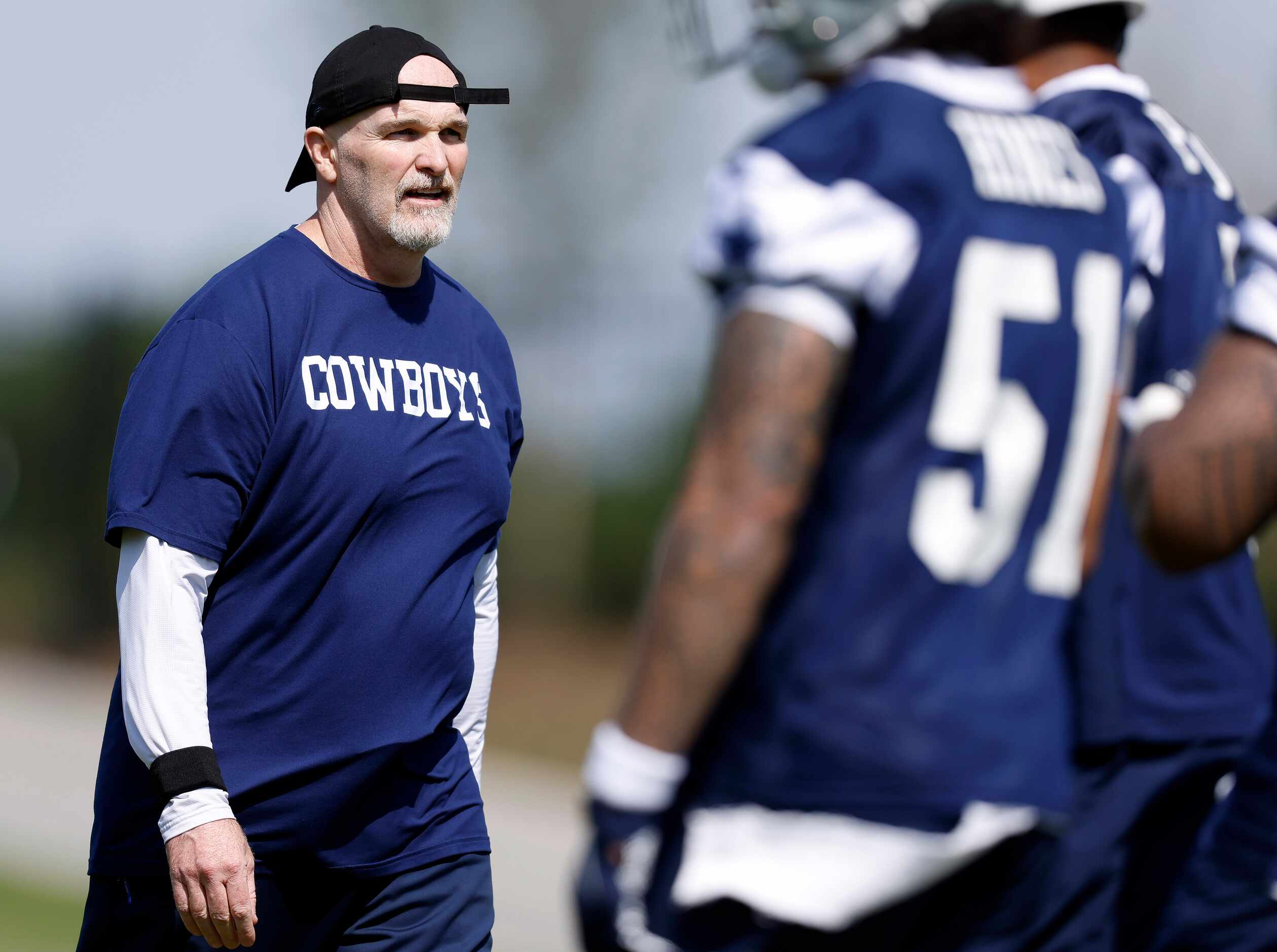 Dallas Cowboys defensive coordinator Dan Quinn lines up his players during rookie minicamp...