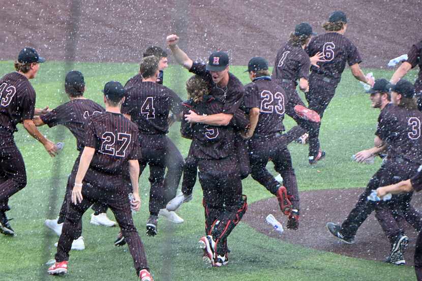 Rockwall Heath players celebrate their 11-3 win during Game 3 of the UIL Region II final...