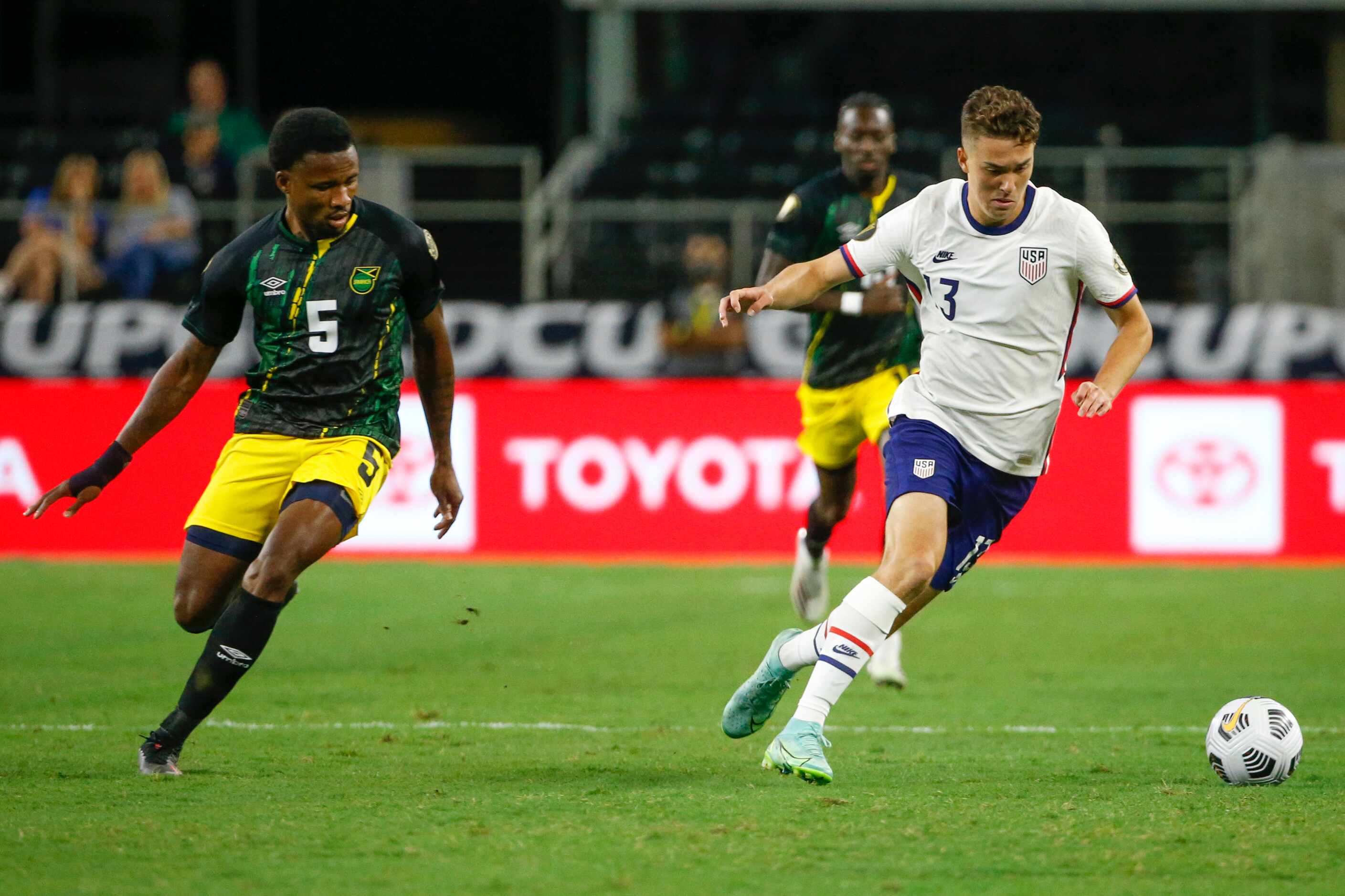 USA forward Matthew Hoppe (13) dribbles away from Jamaica defender Alvas Powell (5) during...