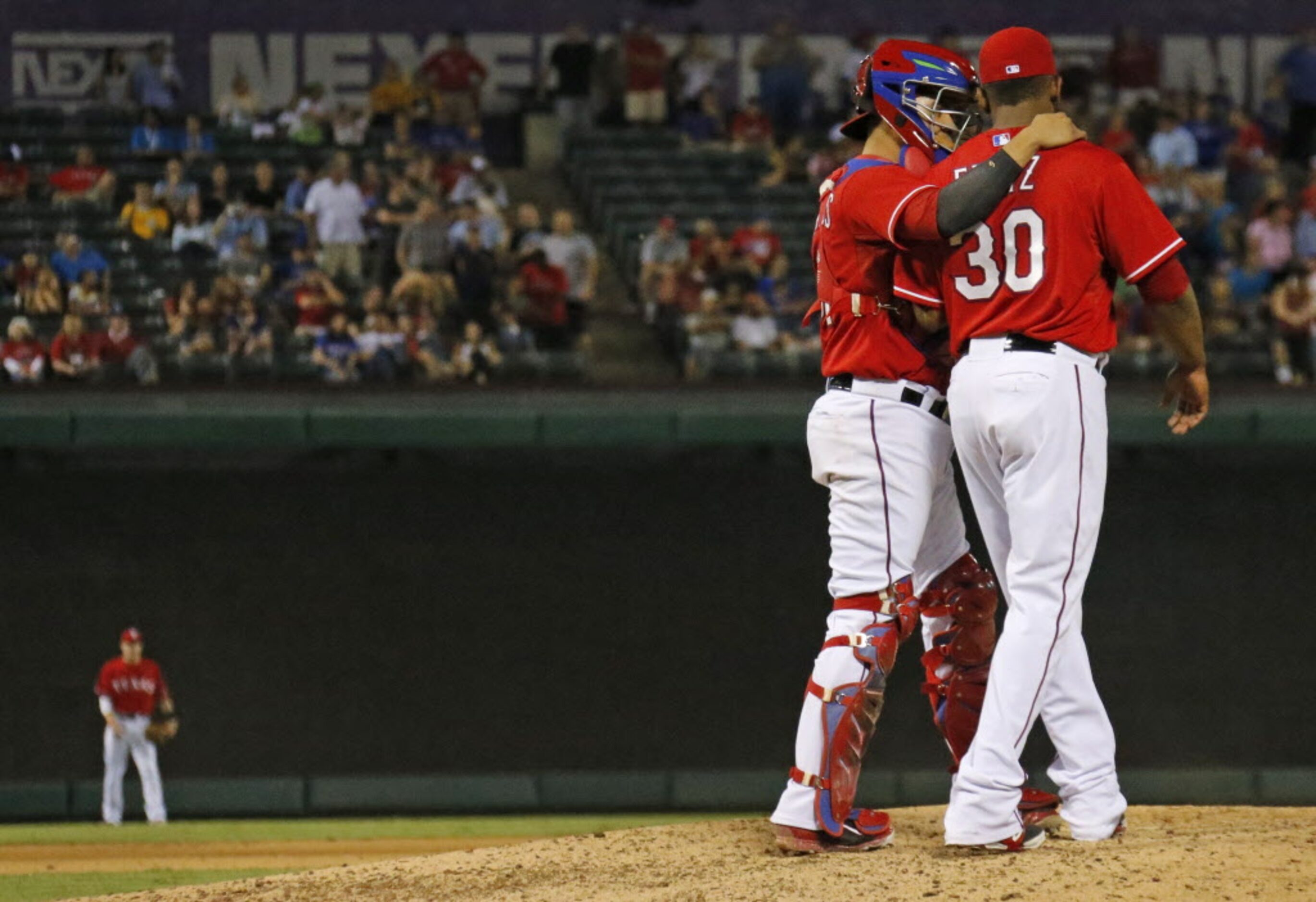 Texas catcher Robinson Chirinos has some encouraging words for closer Neftali Feliz in the...