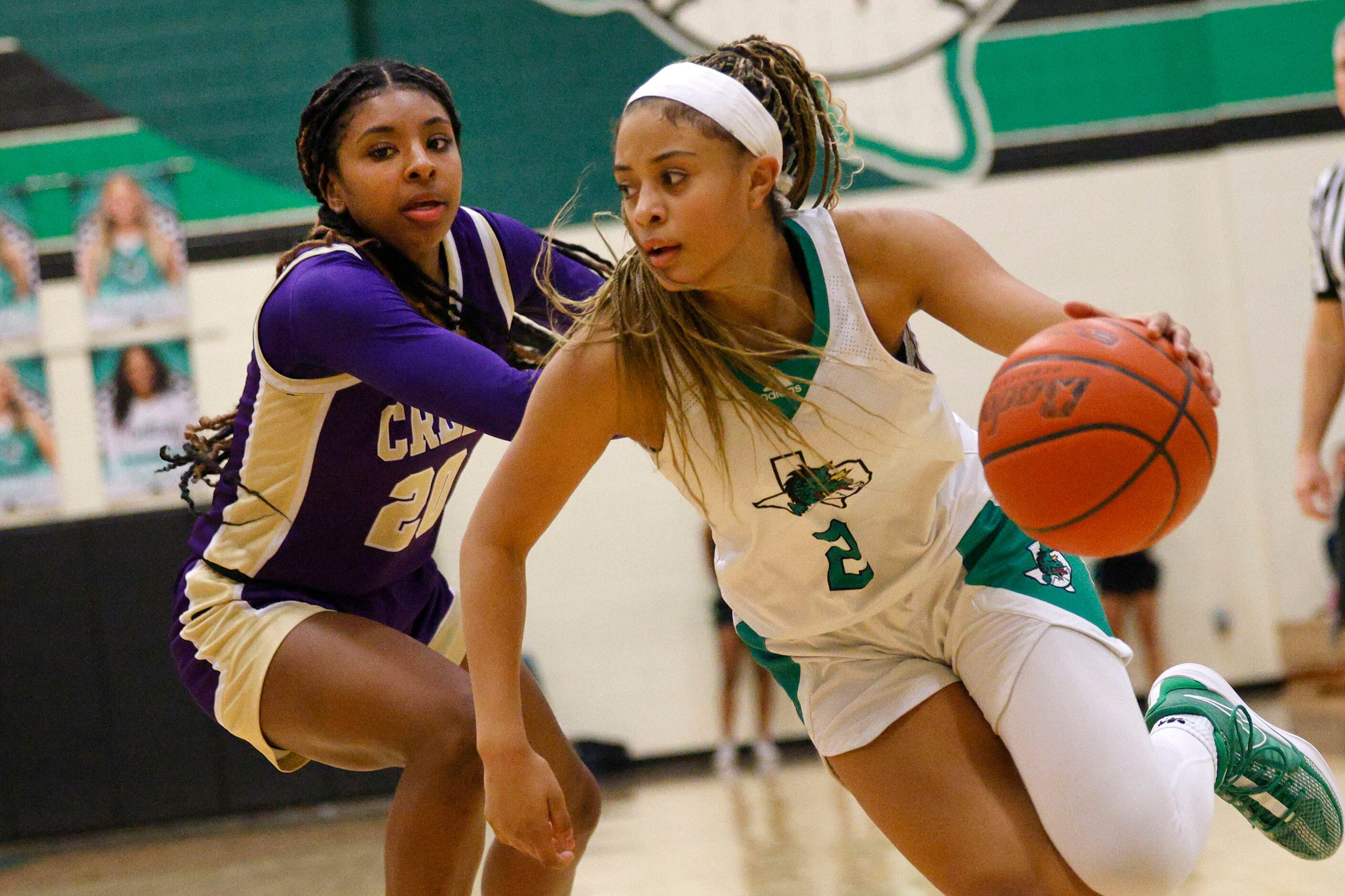 Southlake Carroll's Gianna Jordan (2) tries to drive past Keller Timber Creek's Selah...