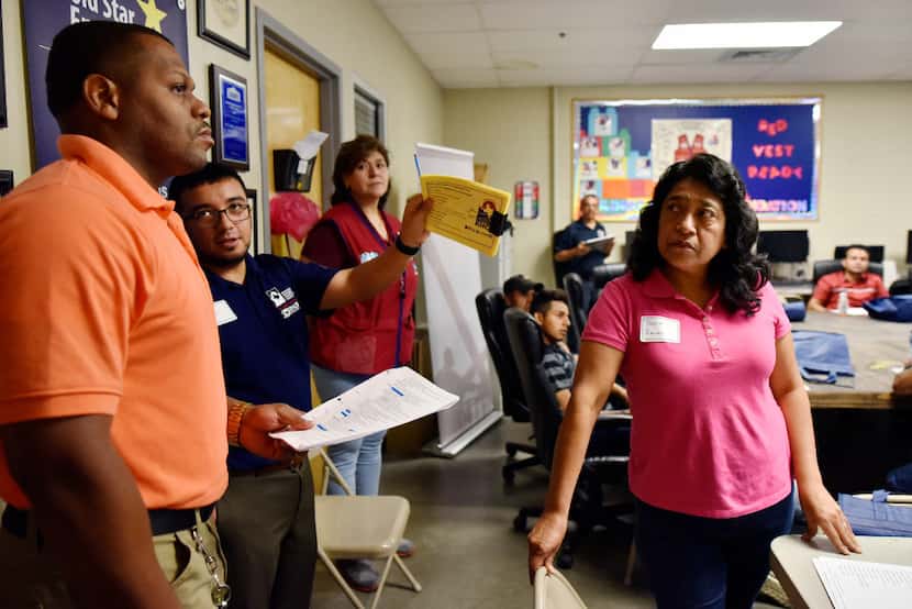 Benita Ramirez (right) listens to Lowe's store manager Bryan Parker during a recent seminar...