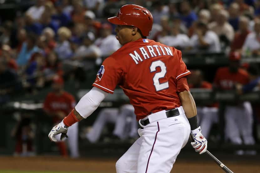 Texas Rangers' Leonys Martin (2) follows through on a three-run double off Houston Astros...