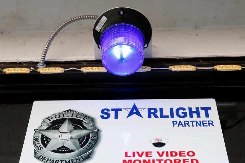The blue light and signage in front of Ferguson Food Mart that marks the business as part of...