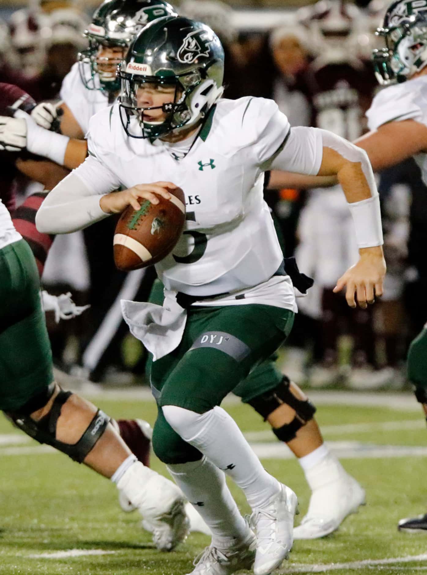 Prosper High School quarterback Jackson Berry (5) scrambles  to get time to pass during the...