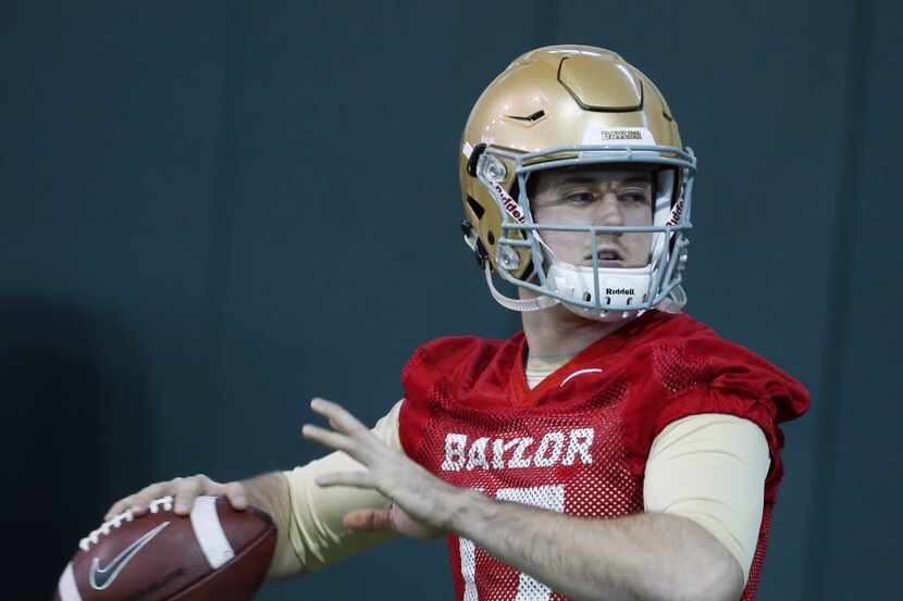 Baylor quarterback Seth Russell warms up during the first day of spring football drills,...